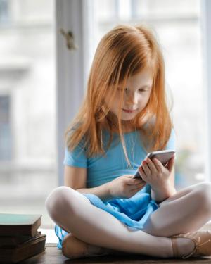 Redhead girl watching phone 