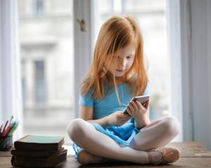 Red-headed girl looking at phone