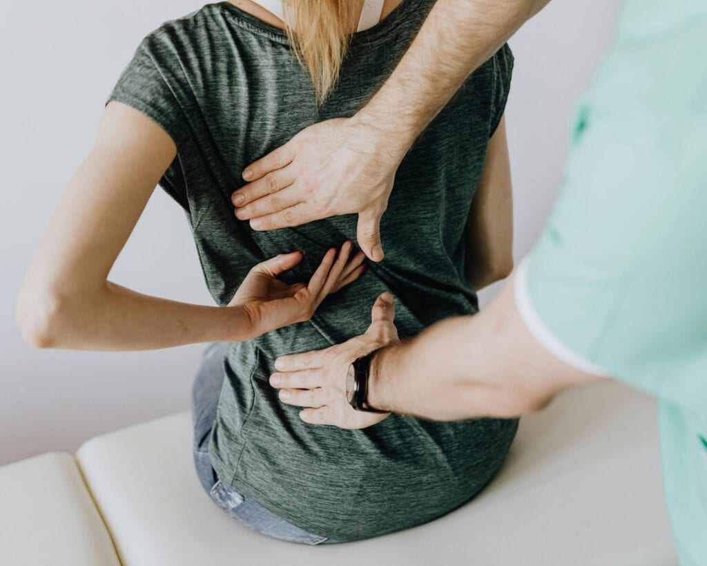 Person receiving injury evaluation from healthcare professional.
