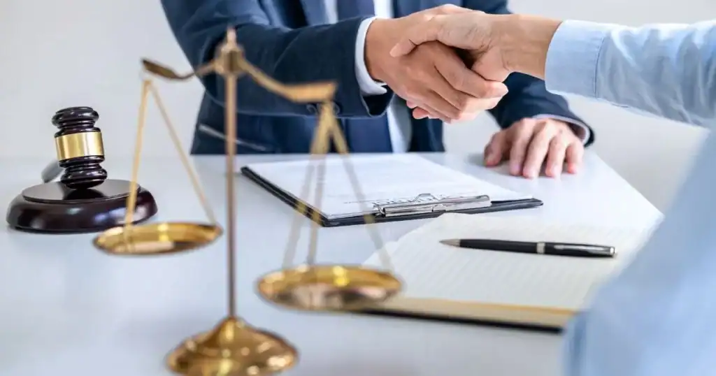 Handshake between lawyer and client in legal office setting in Tulsa OK.
