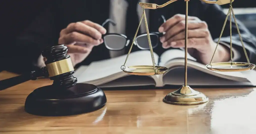 Lawyer reviewing legal documents with scales and gavel in Tulsa, OK.