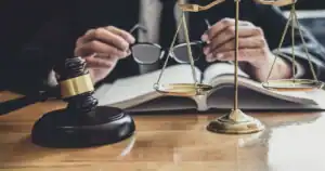Lawyer reviewing legal documents with scales and gavel in Tulsa, OK.
