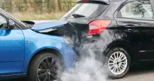 Blue car rear-ended black SUV causing a crash and smoke in Tulsa, OK.